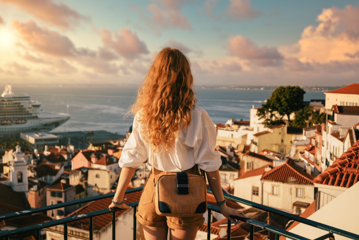 young-female-standing-platform-surrounded-by-fences-observing-lisbon-daytime-portugal.jpg